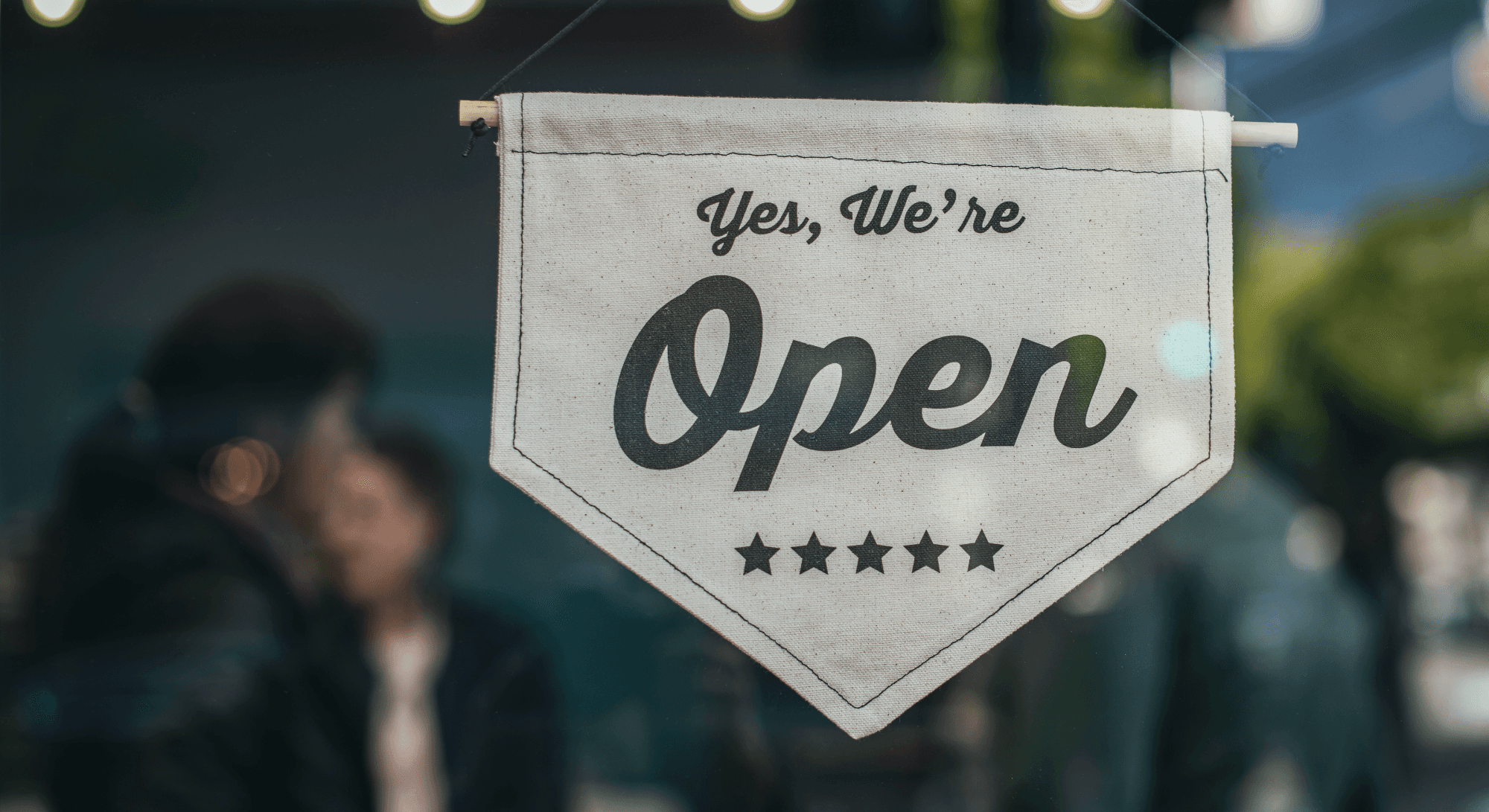 A store sign saying yes we're open.png